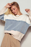 Relaxed fit colorblock knit sweater featuring distressed denim patches in light blue and cream, embodying Long Island boutique fashion.