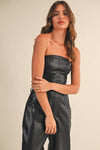 Striking faux leather barrel strapless jumpsuit in sleek black with a fitted bodice and relaxed wide legs, perfect for Long Island boutique fashion.