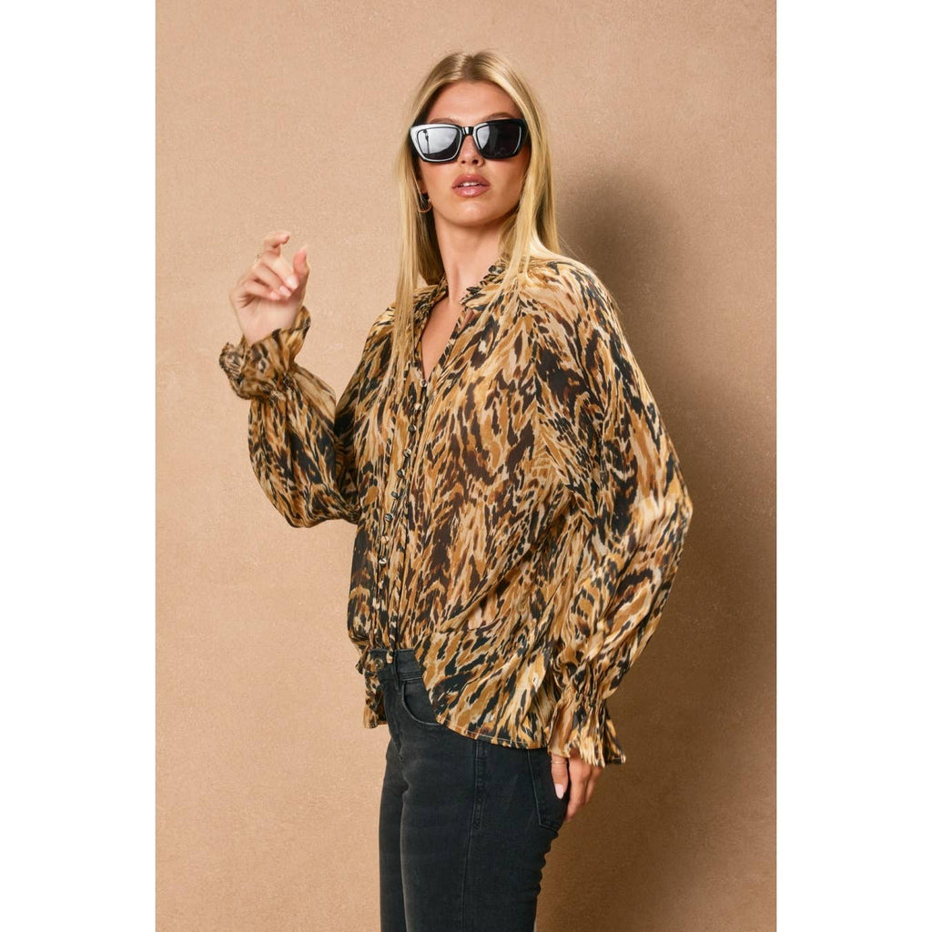 Flowing long-sleeve blouse in a warm, animal print with a collar and button-down front, ideal for chic Long Island boutique fashion.
