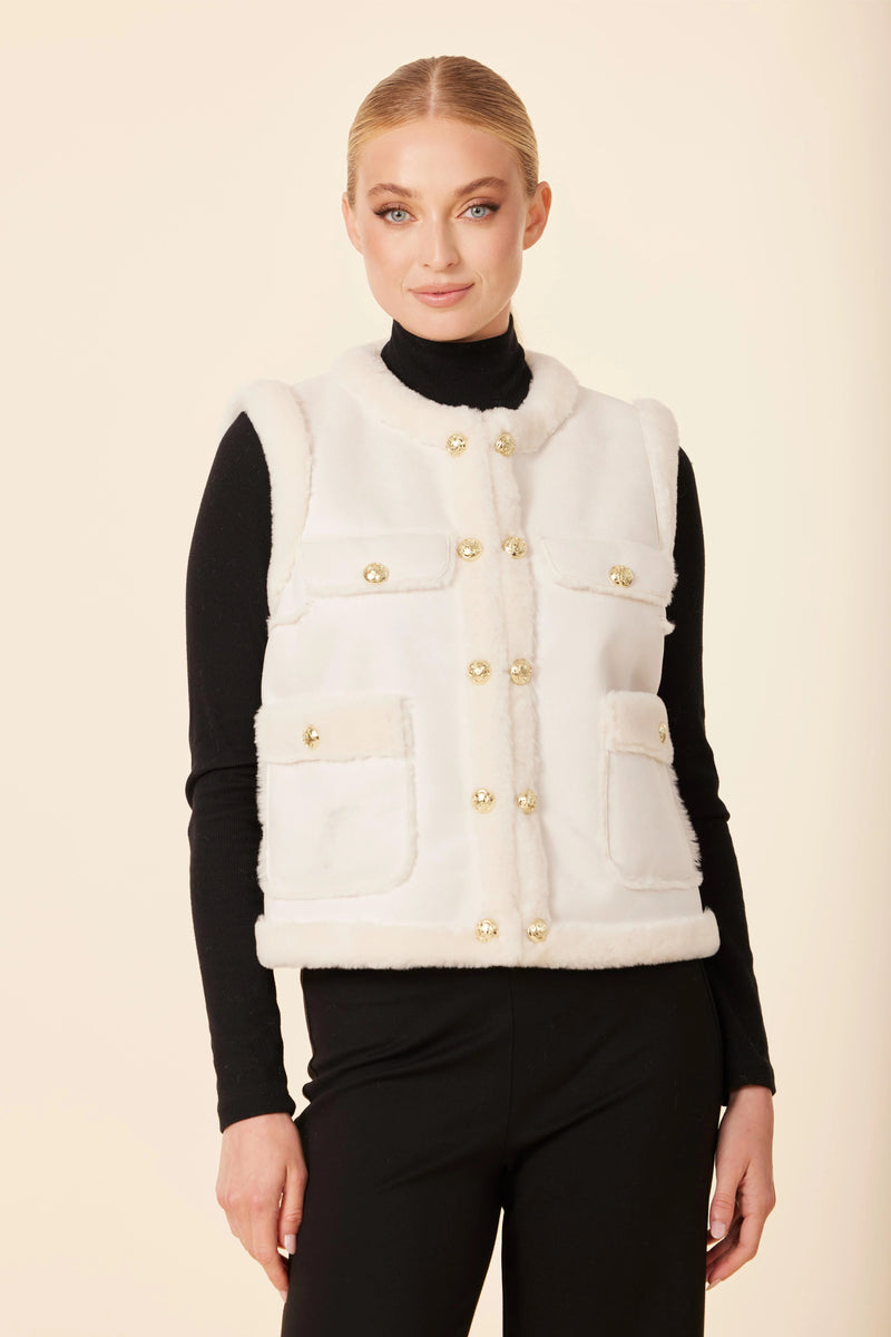 Chic white faux shearling vest with gold button details and front pockets, perfect for layering in Long Island boutique fashion.