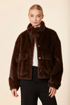 Luxuriously soft chocolate brown faux mink fur jacket features a relaxed fit, snap buttons, and front pockets, perfect for Long Island boutique fashion.