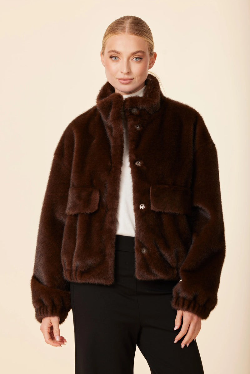 Luxuriously soft chocolate brown faux mink fur jacket features a relaxed fit, snap buttons, and front pockets, perfect for Long Island boutique fashion.
