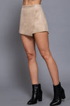 Faux suede short pants in soft beige with a stylish front wrap design, perfect for a chic silhouette in Long Island boutique fashion.