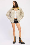 Oversized camo trucker jacket with a brown collar, perfect for layering in Long Island boutique fashion.