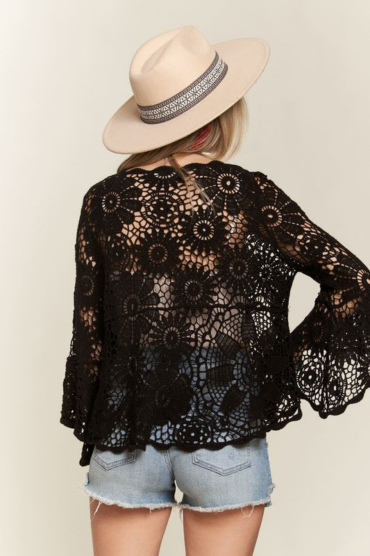 Stylish black bell sleeve crochet top with floral patterns, perfect for a warm day, ideal for Long Island boutique fashion.
