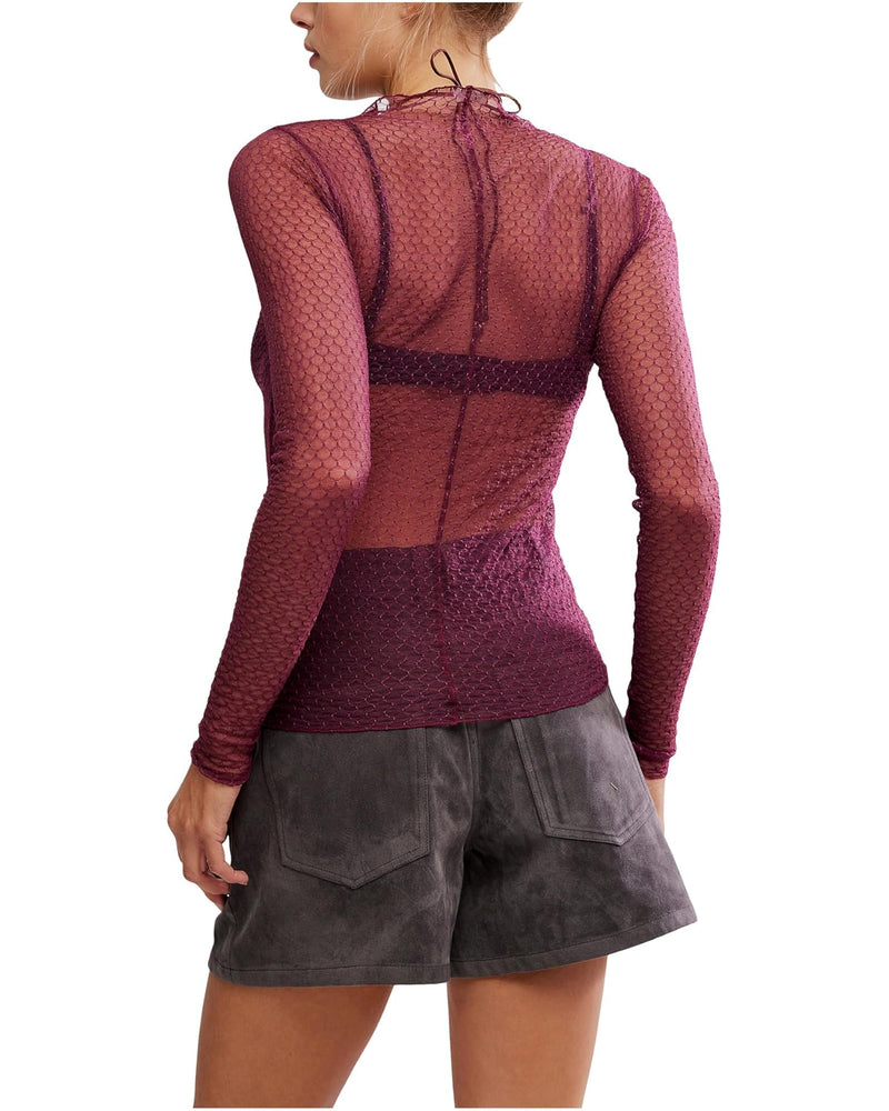Sheer burgundy long-sleeve top with a delicate pattern and fitted silhouette, paired with soft gray suede shorts, perfect for Long Island boutique fashion.