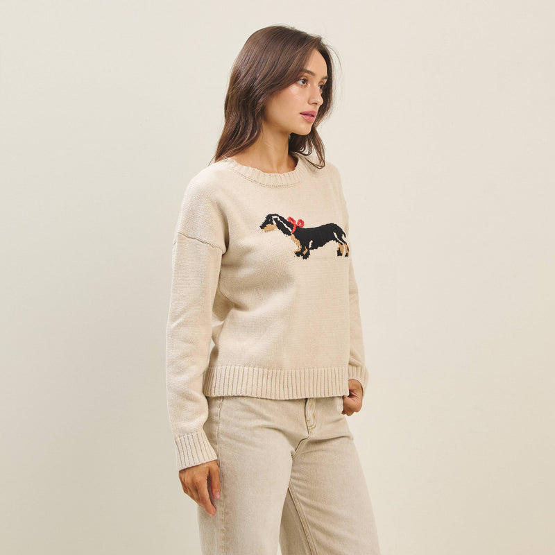 Cream sweater featuring a playful black dog with a red bow, crafted for a cozy fit, perfect for Long Island boutique fashion.