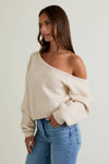 Cozy asymmetrical shoulder sweater top in soft cream, featuring a relaxed fit and ribbed detailing, perfect for Long Island boutique fashion.