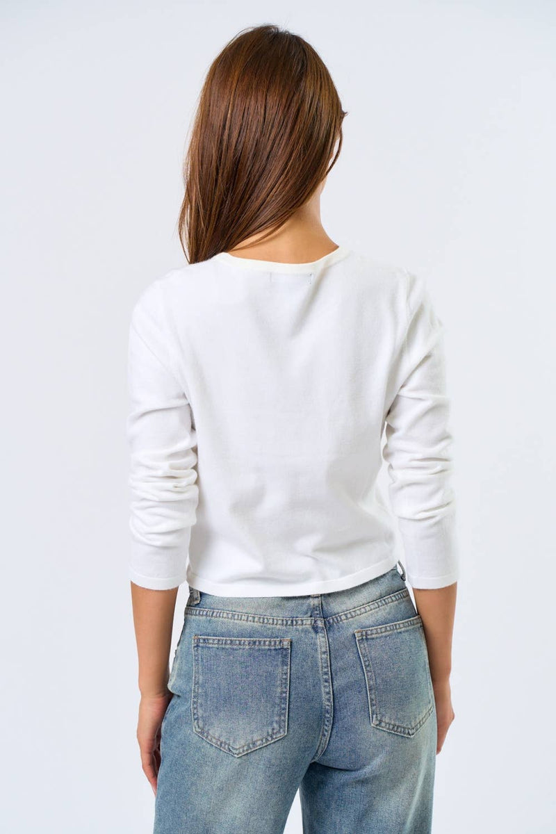 Long-sleeve white baby tee featuring a playful martini graphic, perfect for casual outings in stylish Long Island boutique fashion.