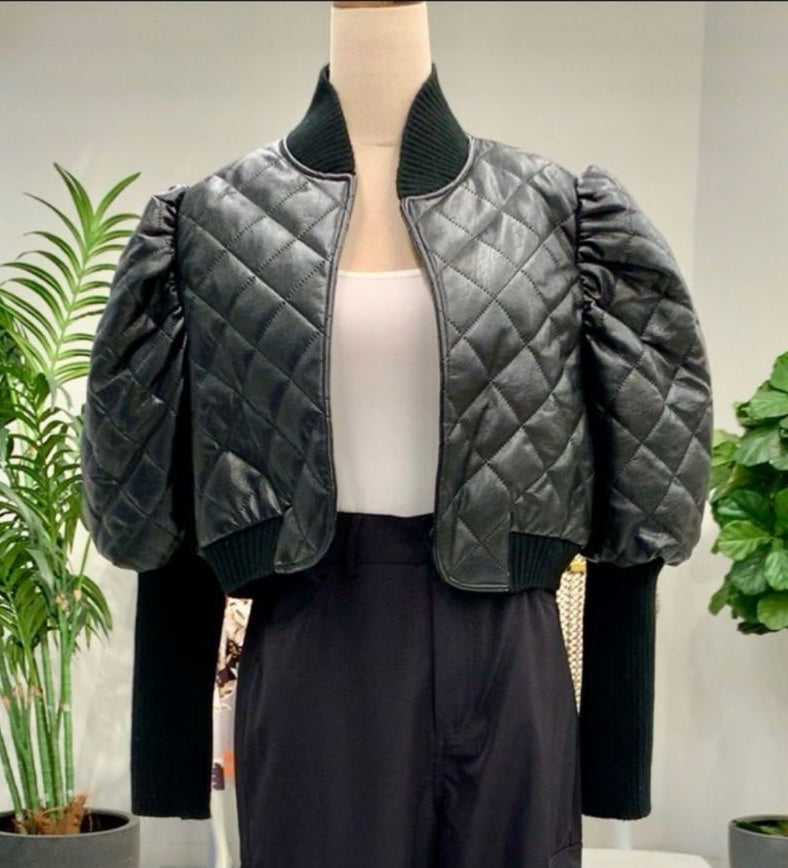 Quilted black puffer leather jacket with voluminous sleeves and ribbed cuffs, a stylish choice for Long Island boutique fashion.