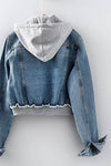 Edgy distressed denim jacket with a zip front and a cozy gray hoodie, perfect for casual Long Island boutique fashion.