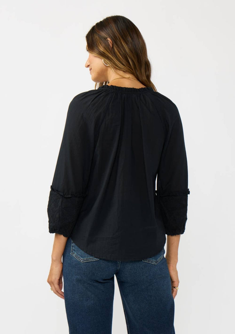 Black frilled sleeve split neck blouse featuring delicate lace details, perfect for effortless style from a Long Island boutique fashion.
