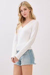 Fitted double-layer V-neck long sleeve top in soft white, perfect for layering with shorts, ideal for Long Island boutique fashion.
