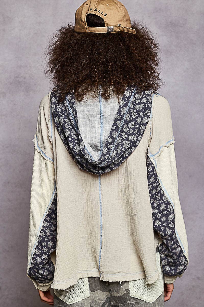 Lightweight gauze color block hoodie top featuring a floral-patterned navy hood, relaxed fit, and raw edge detailing, perfect for Long Island boutique fashion.