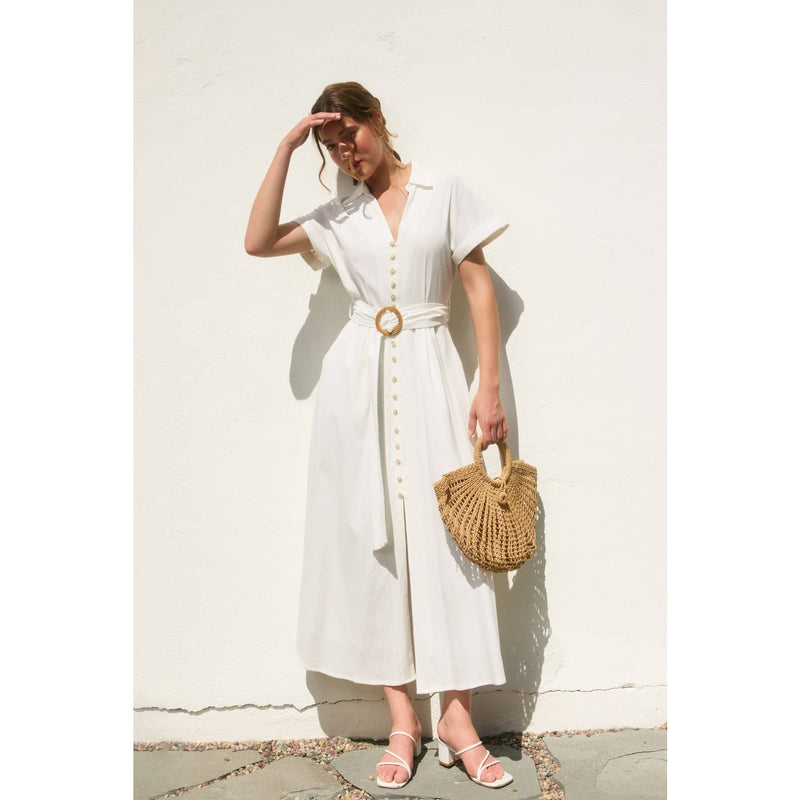 Flowy white maxi dress with short sleeves, button details, and a straw belt buckle, perfect for Long Island boutique fashion.