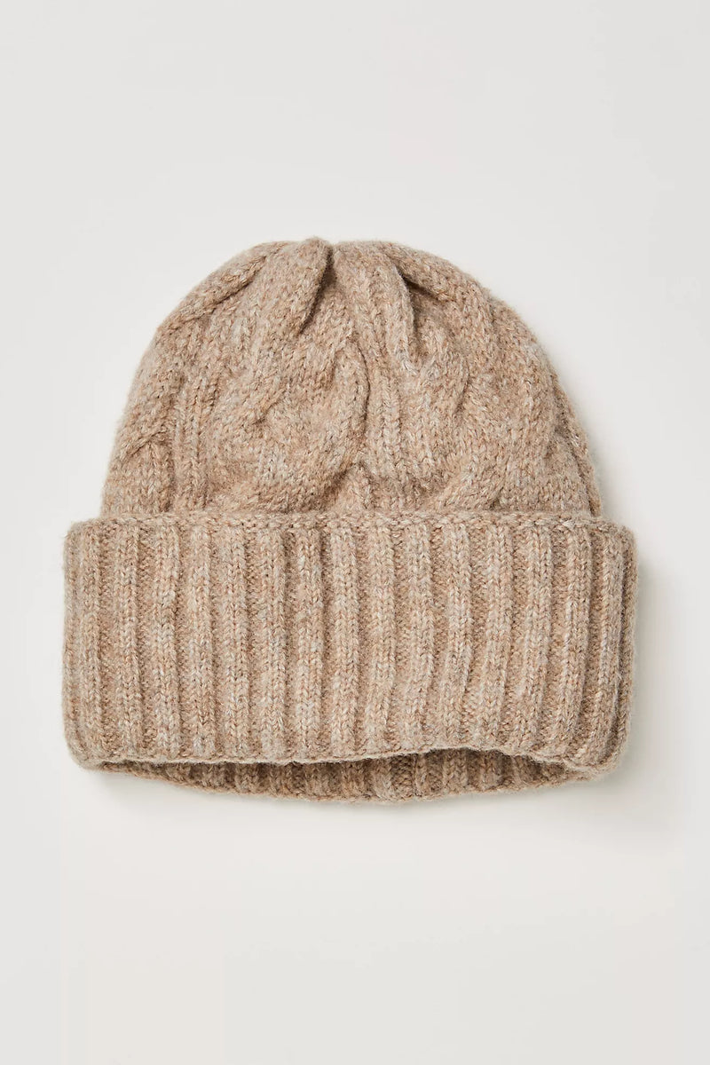 Cozy beige cable-knit beanie with a textured fold-over cuff, perfect for adding warmth to any outfit in Long Island boutique fashion.