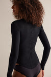 Model wearing Free People Going Places Cardi Top in black — slim thermal knit with snap-front closure, available at TandyWear Boutique in Commack, NY. back view black