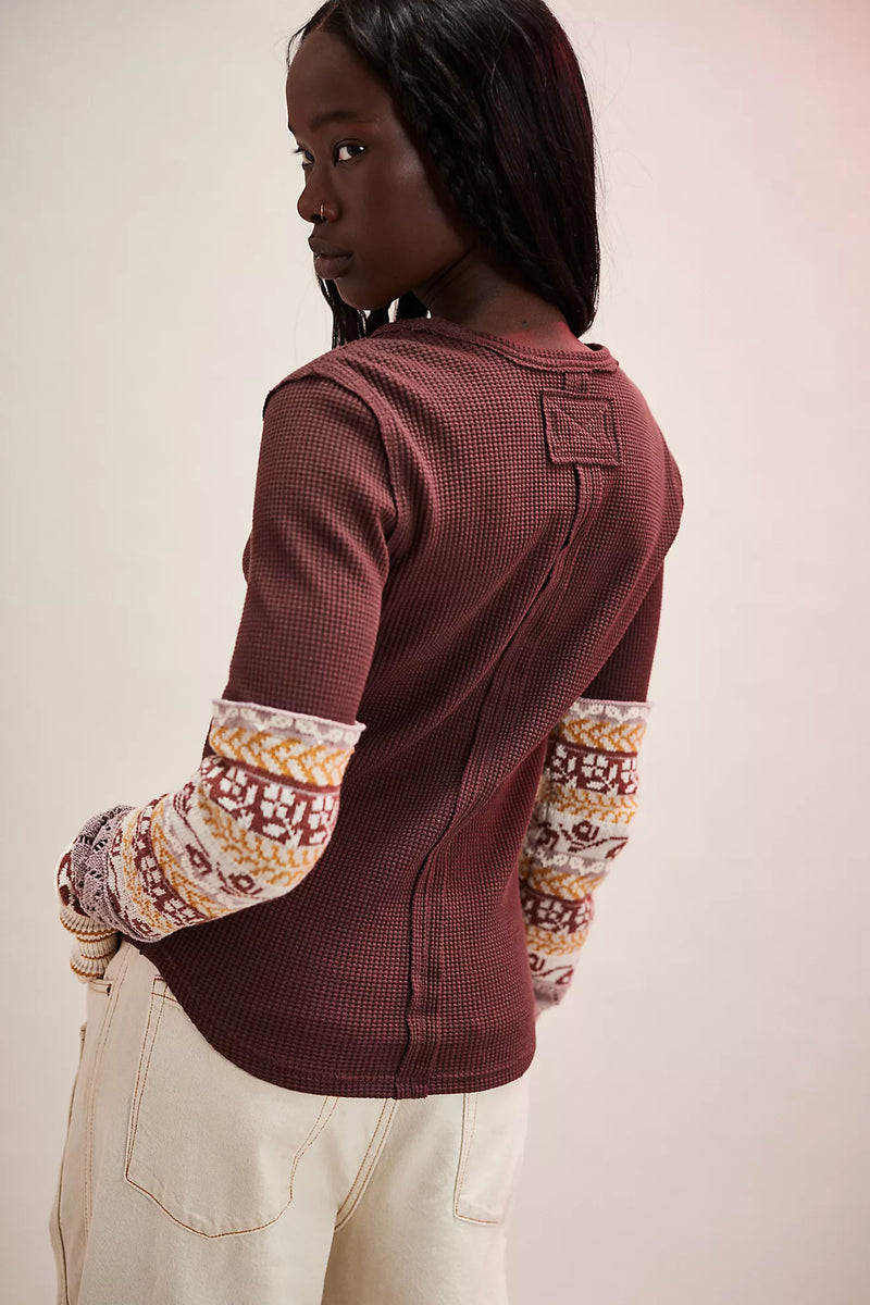 Long-sleeve burgundy top featuring textured fabric and patterned cuffs, perfect for cozy days in Long Island boutique fashion.