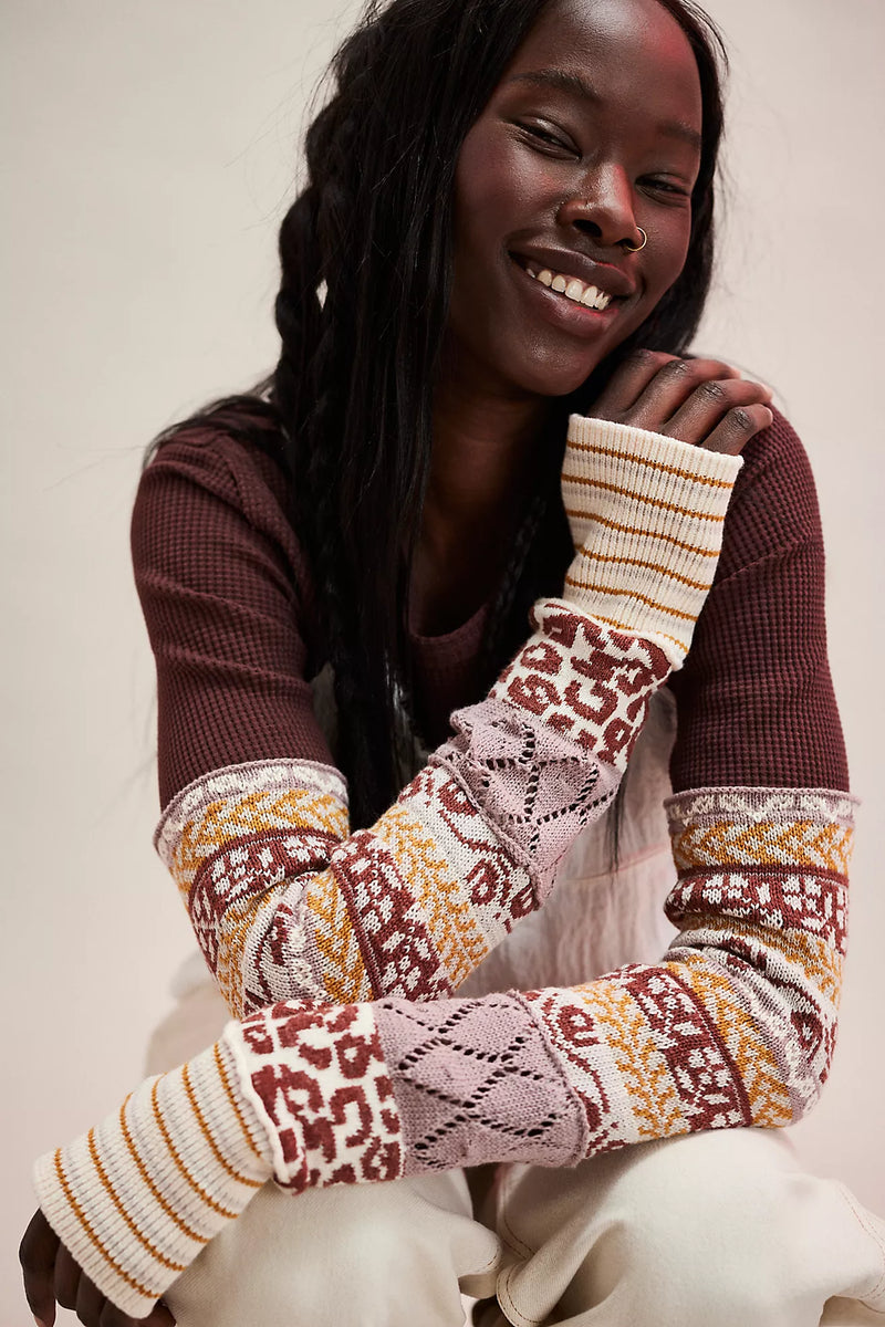 Stylish burgundy ribbed Free People top featuring intricate patterned sleeves with lace and bold colors, perfect for Long Island boutique fashion.