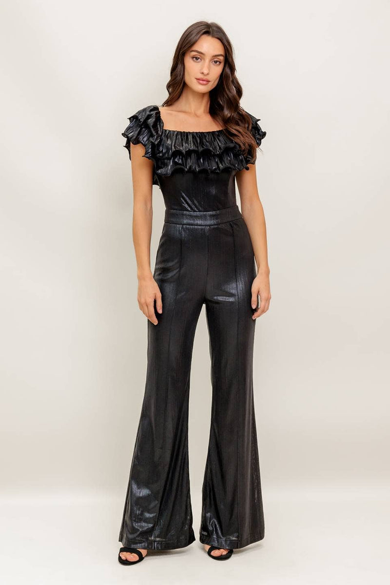 Black coated woven jumpsuit with a ruffled off-the-shoulder neckline and flared legs, perfect for Long Island boutique fashion.