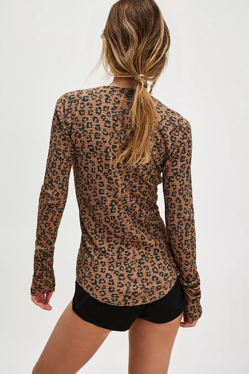 Leopard-print cardigan in warm brown tones, featuring a fitted silhouette and long sleeves, perfect for Long Island boutique fashion.