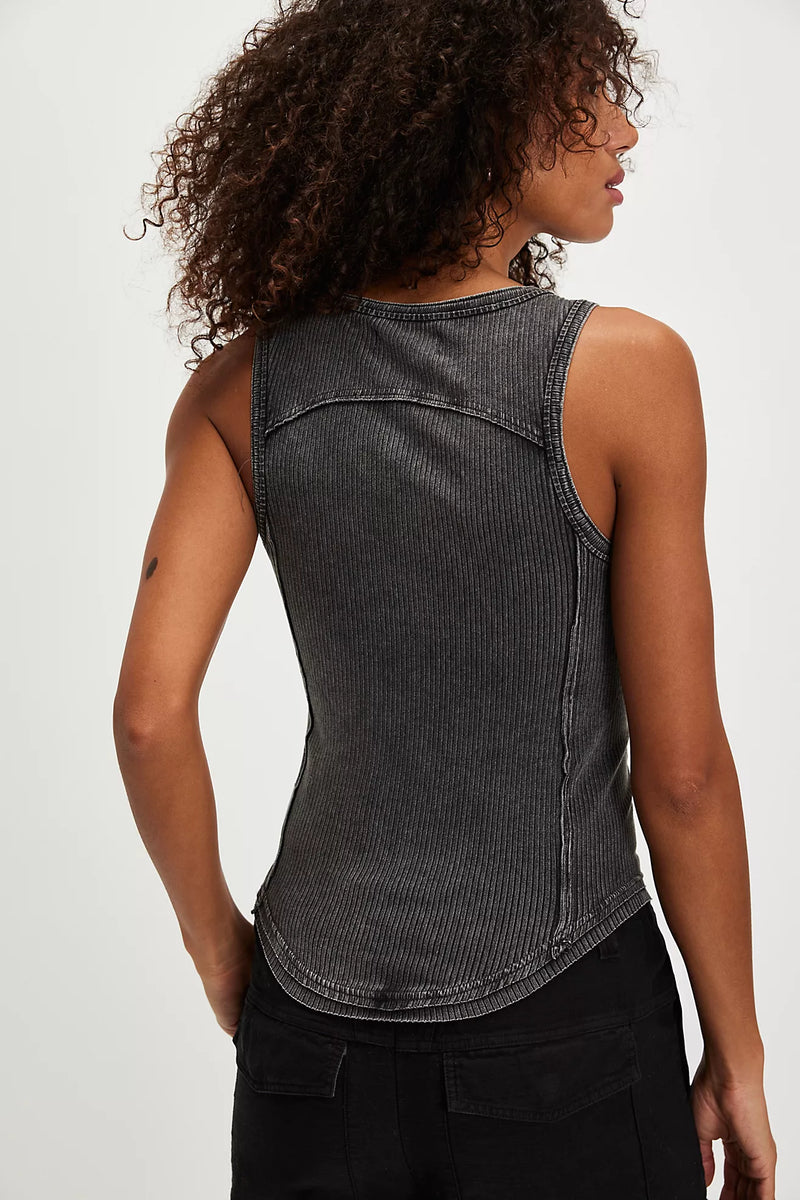Model wearing Free People Jamie Tank Top in black — ribbed cotton design with overall-inspired buckle straps, available at TandyWear Boutique in Commack, NY. back view