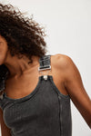 Model wearing Free People Jamie Tank Top in black — ribbed cotton design with overall-inspired buckle straps, available at TandyWear Boutique in Commack, NY. view of buckle strap