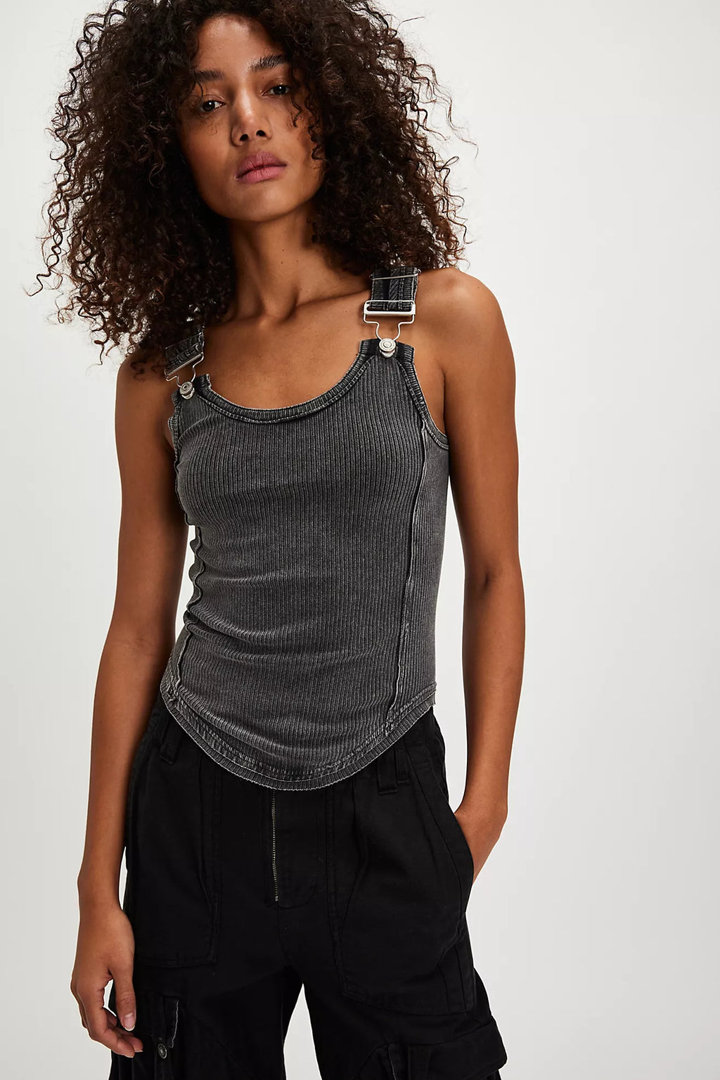 Model wearing Free People Jamie Tank Top in black — ribbed cotton design with overall-inspired buckle straps, available at TandyWear Boutique in Commack, NY. front view 