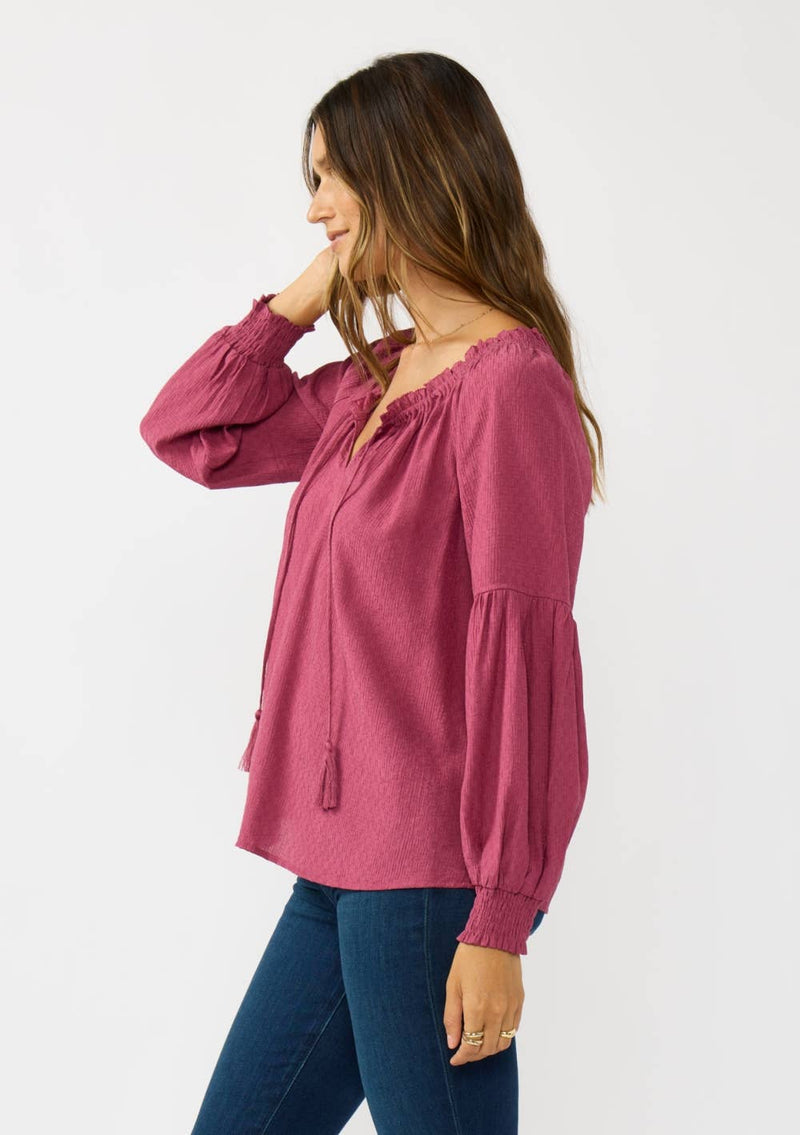 Bishop raglan long sleeve boho top in rich berry hue features a relaxed fit and stylish tassel tie, perfect for Long Island boutique fashion.