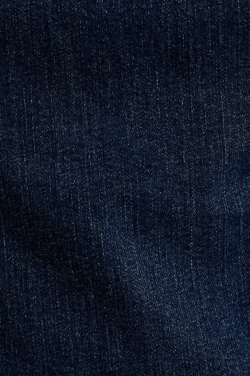 Asymmetrical shoulder denim dress in deep indigo, featuring a fitted silhouette and subtle texture, perfect for Long Island boutique fashion.