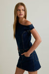 Stylish asymmetrical shoulder denim dress in dark blue, featuring a fitted bodice and playful skirt for a chic Long Island boutique fashion look.