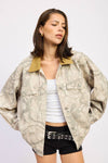 Oversized camo trucker jacket in neutral tones features a contrasting mustard collar, perfect for trendy Long Island boutique fashion.
