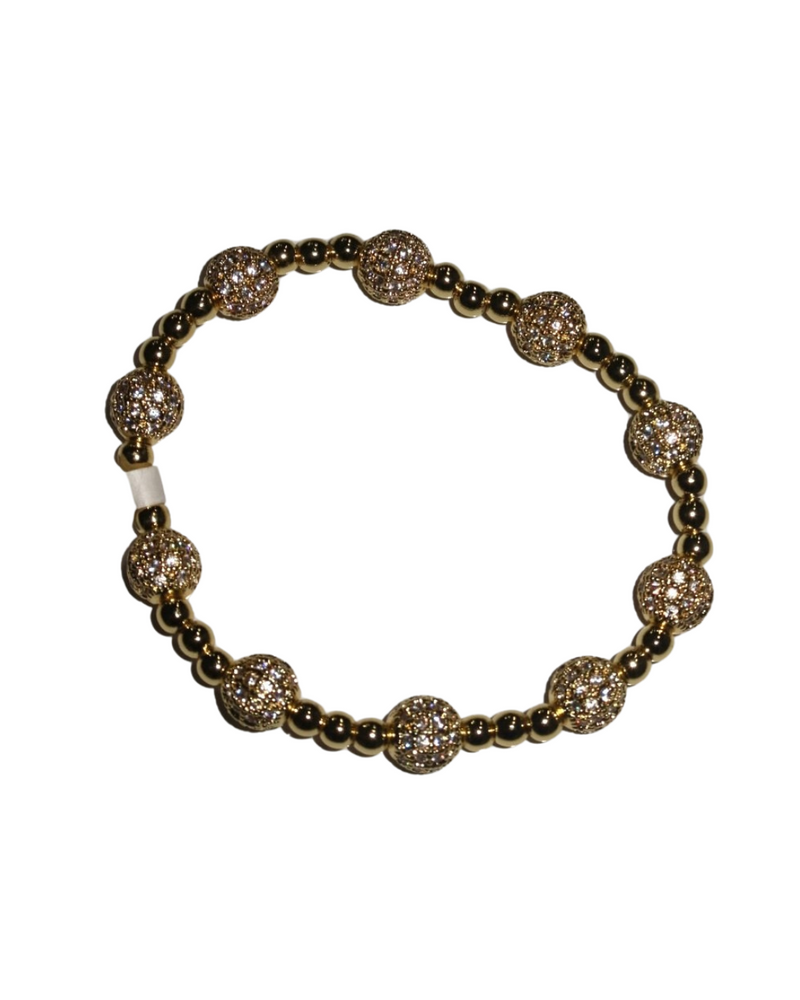 Gold stretch bracelet featuring pave bead accents and smooth gold spheres, perfect for adding sparkle to any outfit in Long Island boutique fashion.