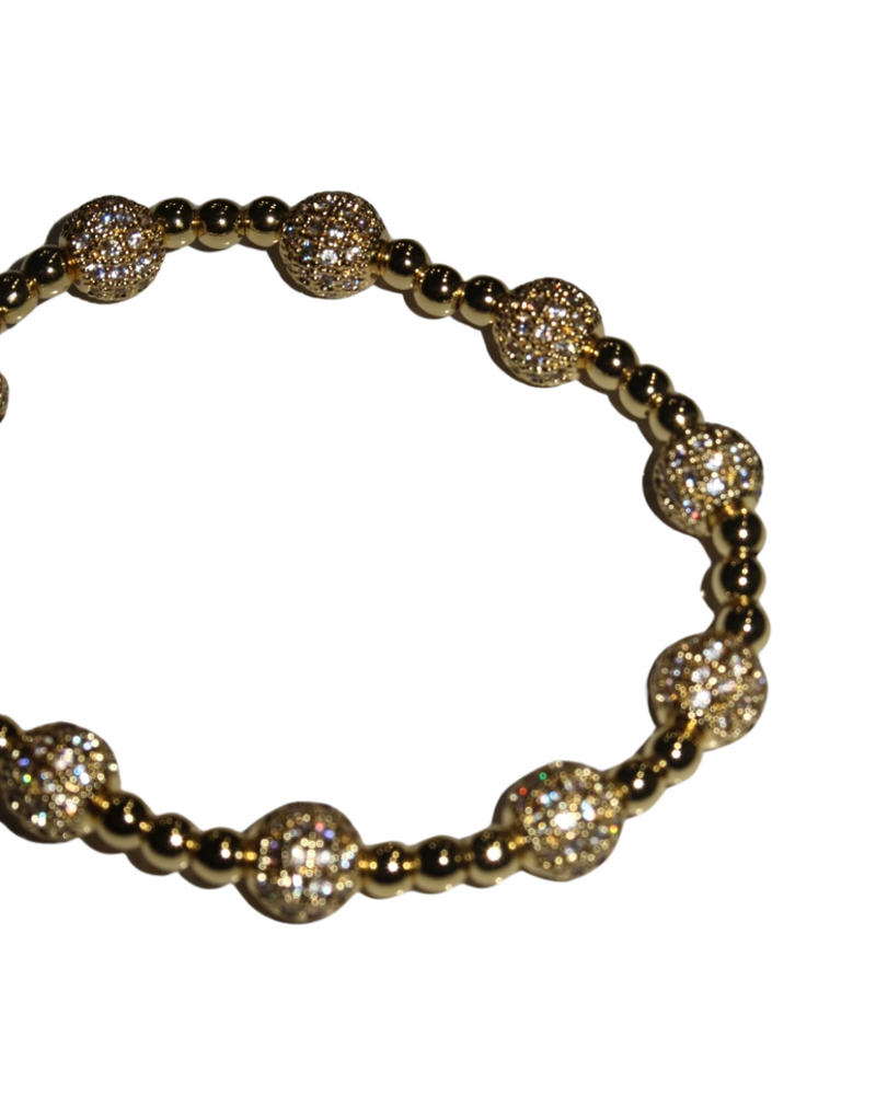 Gold stretch bracelet featuring pave bead accents and polished round beads, perfect for adding sparkle to any outfit in a Long Island boutique fashion.