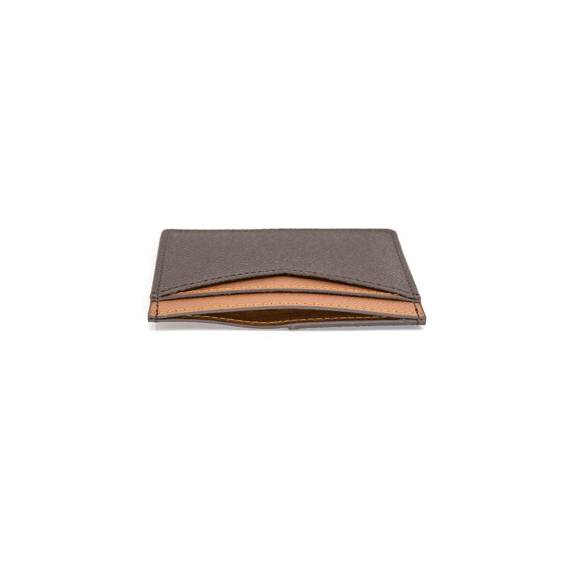 Sleek brown BC credit card holder featuring a textured exterior and contrasting interior, perfect for stylish Long Island boutique fashion.