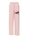 Soft pink sweatpants featuring a graphic of a golfer on a convertible, showcasing vibrant Long Island boutique fashion style.