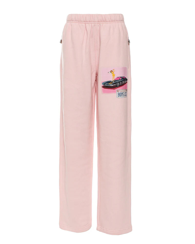 Soft pink sweatpants featuring a graphic of a golfer on a convertible, showcasing vibrant Long Island boutique fashion style.