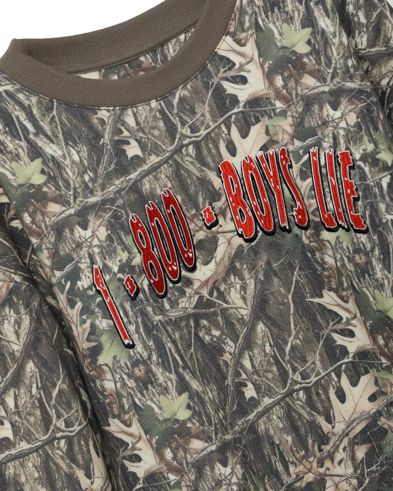 Camouflage crewneck sweatshirt featuring bold "1-800 BOYS LIE" lettering, perfect for casual outings in Long Island boutique fashion.