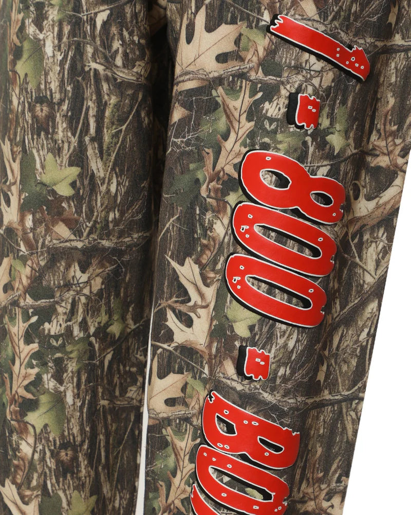 Camouflage pants featuring bold red "1-800" lettering, ideal for casual wear in Long Island boutique fashion.