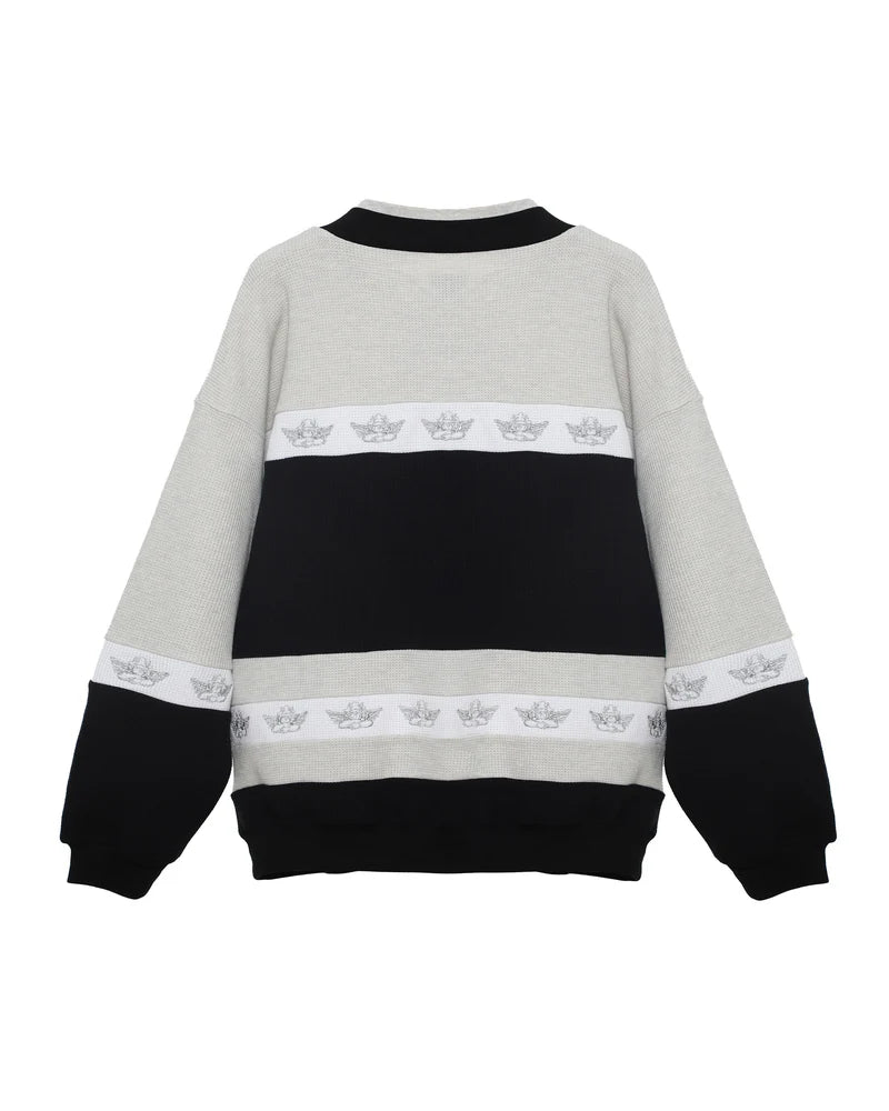 Cozy crewneck in heather gray, black, and white with a relaxed fit and graphic detail, embodying Long Island boutique fashion.