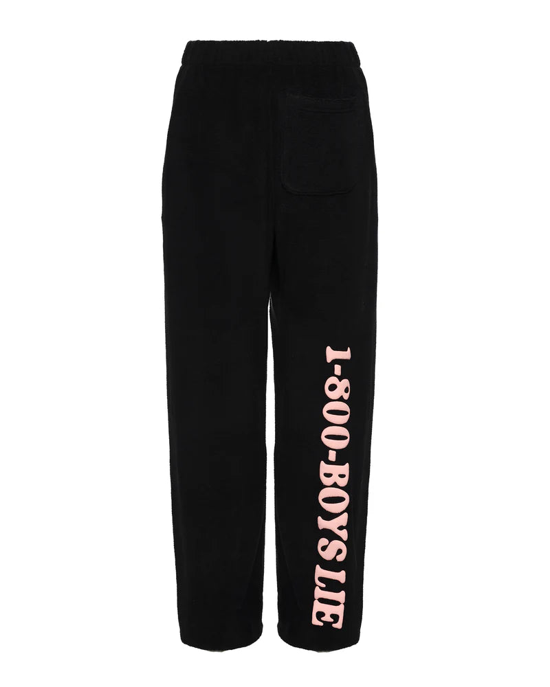 Black mac slim pants featuring a playful "1-800-Boys Lie" print in soft pink, perfect for casual wear at a Long Island boutique fashion.