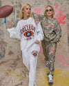 Cozy white crewneck sweatshirt with "Football League College" graphic, paired with matching pants, showcasing casual Long Island boutique fashion.