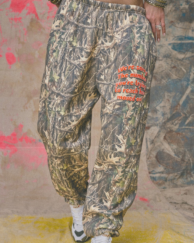 Camo patterned jogger pants featuring an elastic waistband and bold red text, perfect for casual wear from a Long Island fashion boutique.