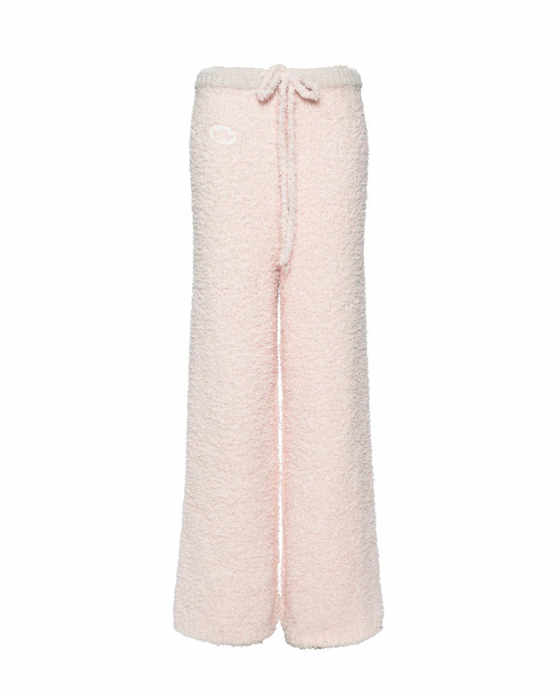 Cozy pink sweatpants with a fuzzy texture and adjustable drawstring, perfect for lounging in style at a Long Island women's boutique.