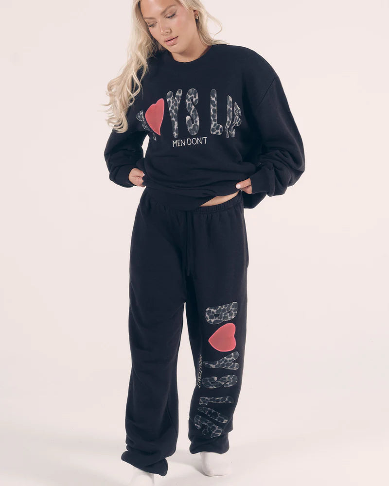 Soft black sweatpants featuring playful cheetah print graphics and a relaxed fit, perfect for lounging in Long Island boutique fashion.