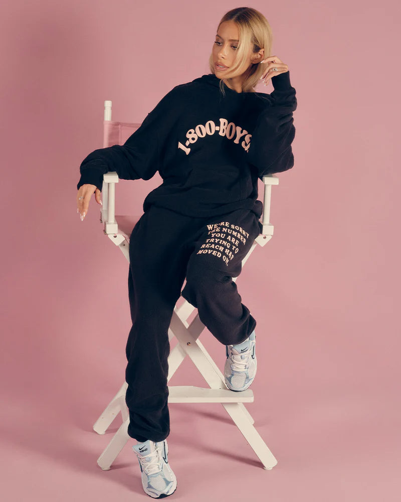 Slim black sweatpants from Boys Lie featuring a unique graphic in white text, perfect for trendy Long Island boutique fashion.