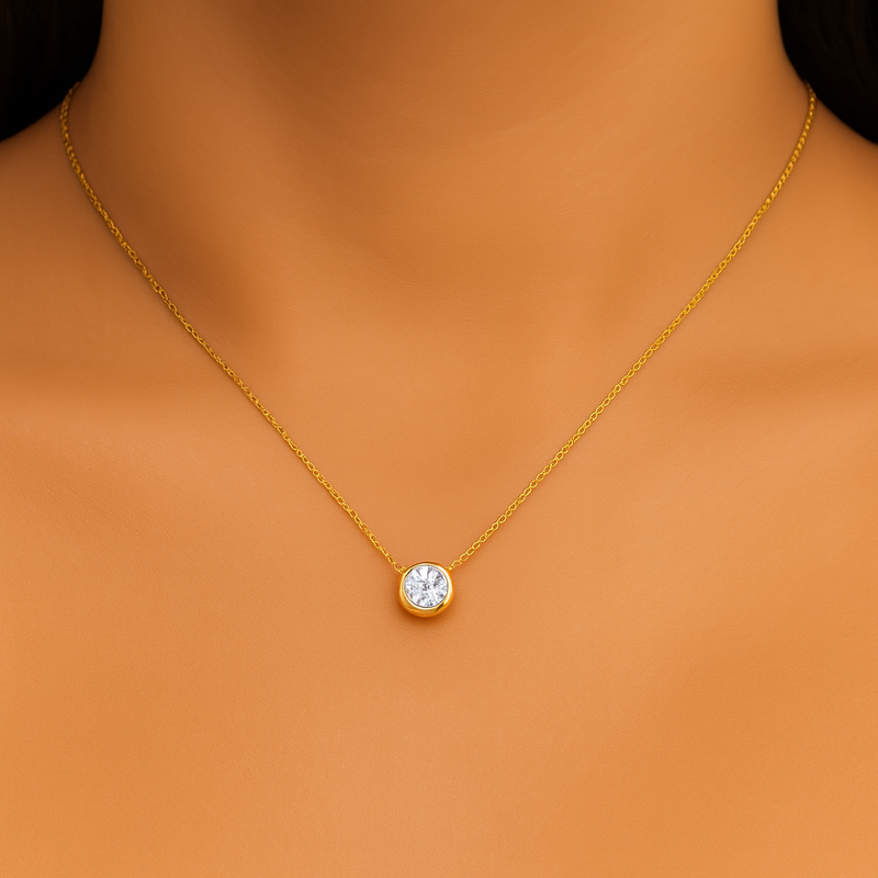 Gold necklace with a round pendant on a model against an orange background