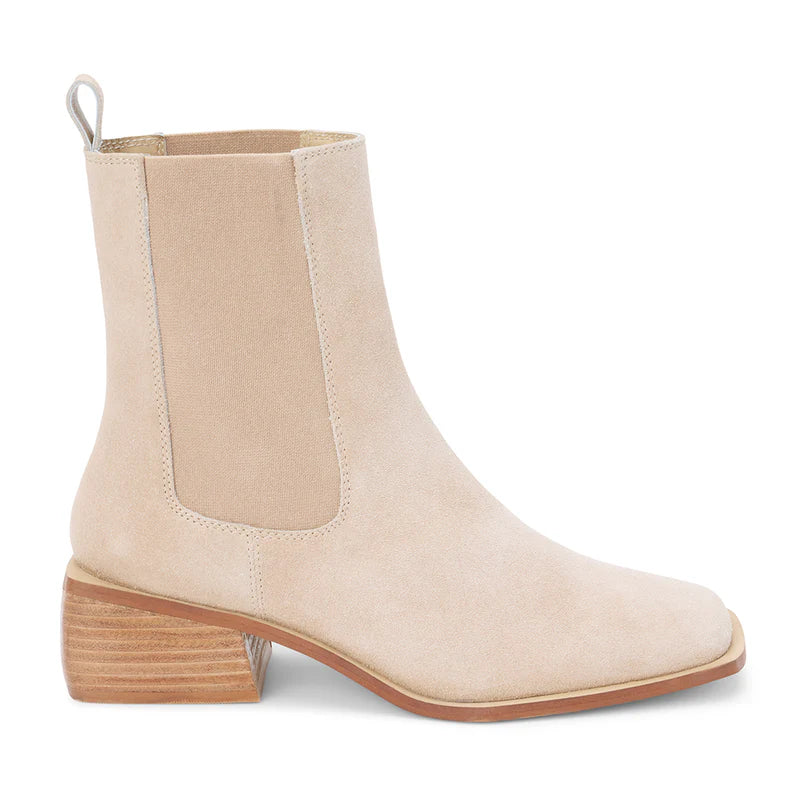 Soft beige ankle boots with a sleek silhouette, elastic side panels, and a stylish block heel perfect for Long Island boutique fashion.