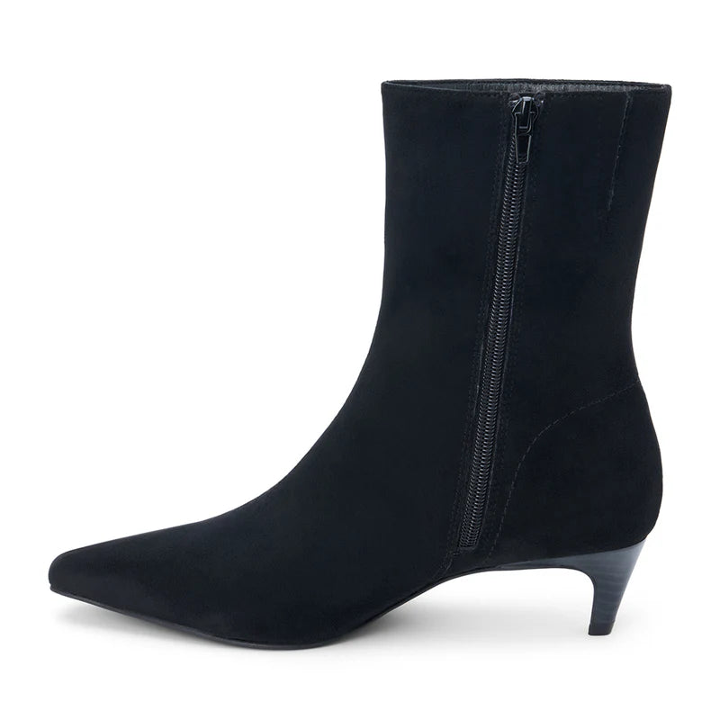 Black suede ankle boot with a pointed toe, sleek silhouette, and a side zipper, perfect for an elegant touch in Long Island boutique fashion.