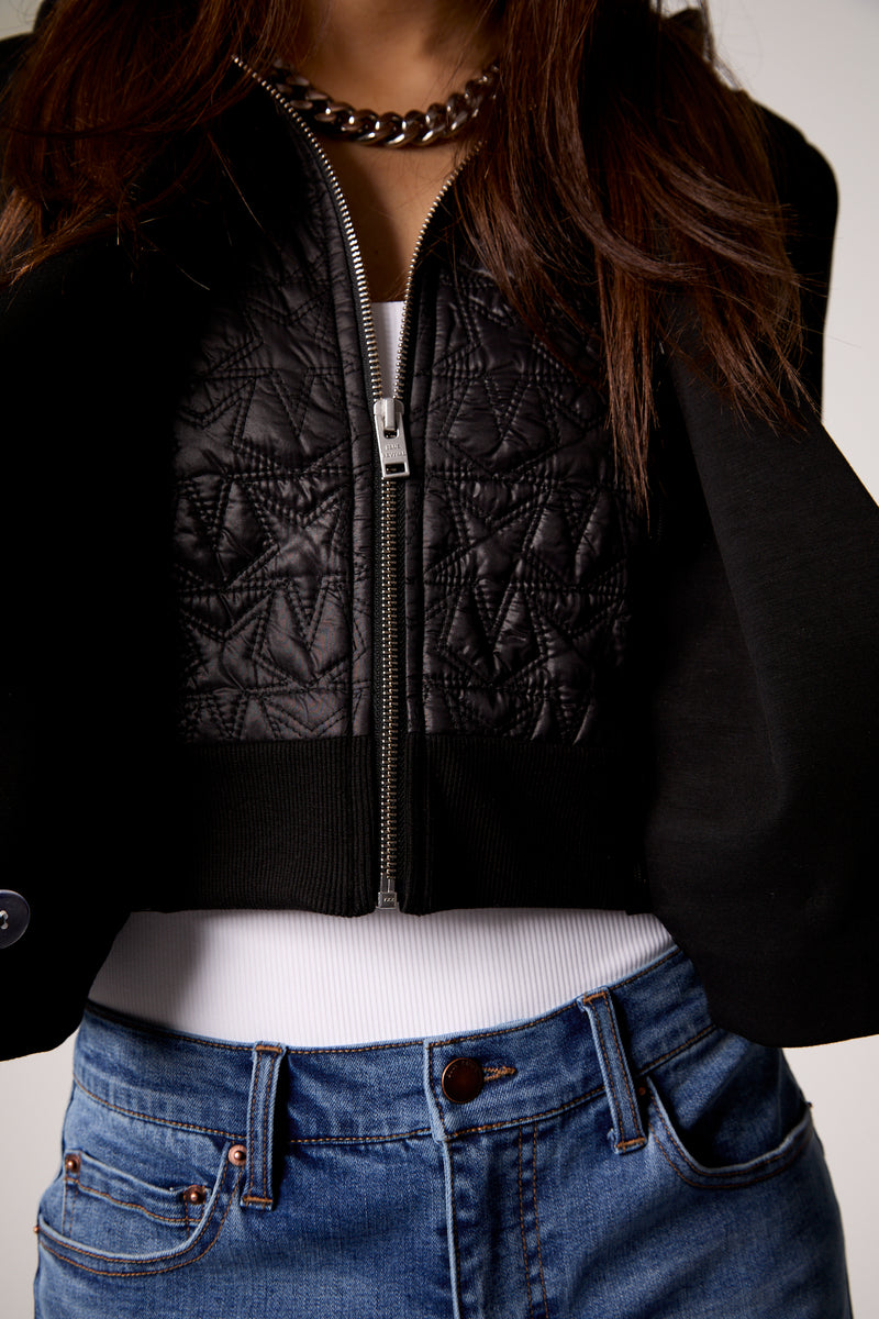 Cropped blazer featuring a blue exterior and black quilted detail, ideal for layering in stylish Long Island boutique fashion.